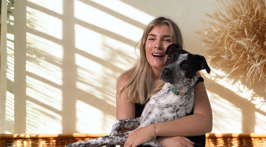 Girl hugging dog with Oh Vienna Collar