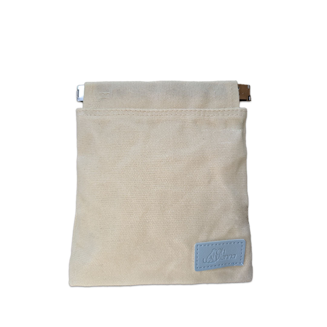Beige canvas dog treat bag featuring a blue Oh Vienna logo and a convenient squeeze pouch closure